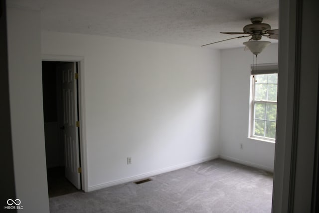 8912 Hosta Way, Indianapolis, IN 46113 - empty room featuring light colored carpet, ceiling fan, and a textured ceiling