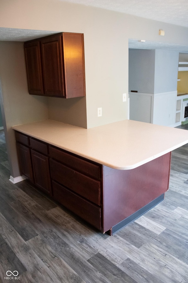 8912 Hosta Way, Indianapolis, IN 46113 - kitchen featuring dark wood-style flooring, light countertops, and a peninsula