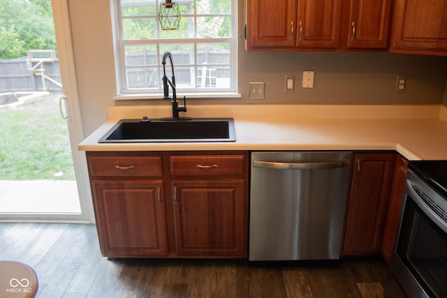 8912 Hosta Way, Indianapolis, IN 46113 - kitchen with appliances with stainless steel finishes, light countertops, dark wood finished floors, and brown cabinets