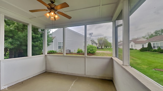 unfurnished sunroom with ceiling fan