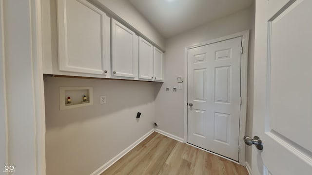 laundry room featuring cabinet space, washer hookup, baseboards, and light wood-style flooring