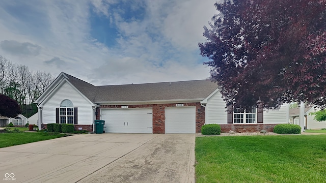 view of front of house featuring a shingled roof, an attached garage, a front lawn, brick siding, and concrete driveway