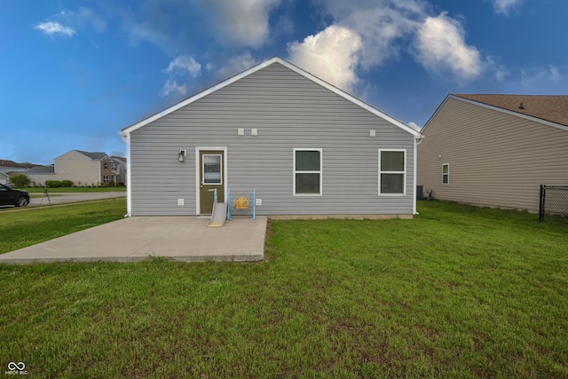 rear view of house with a yard and a patio area