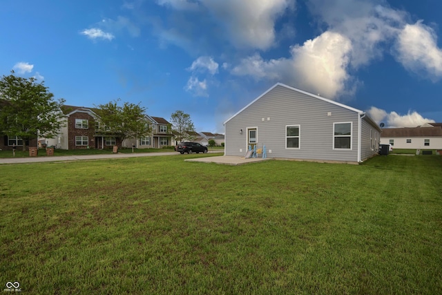 rear view of property with a lawn