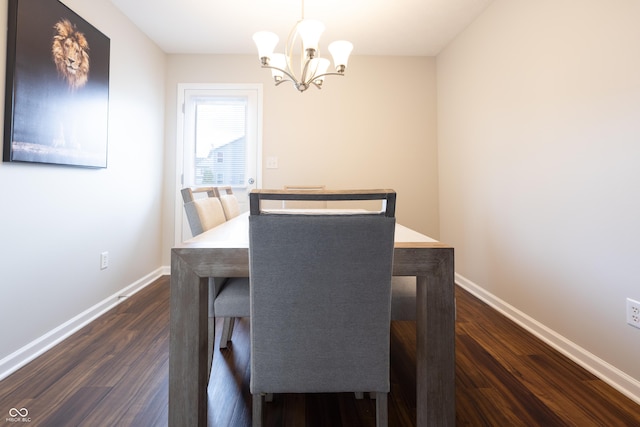 dining room with a chandelier, dark wood-style flooring, and baseboards