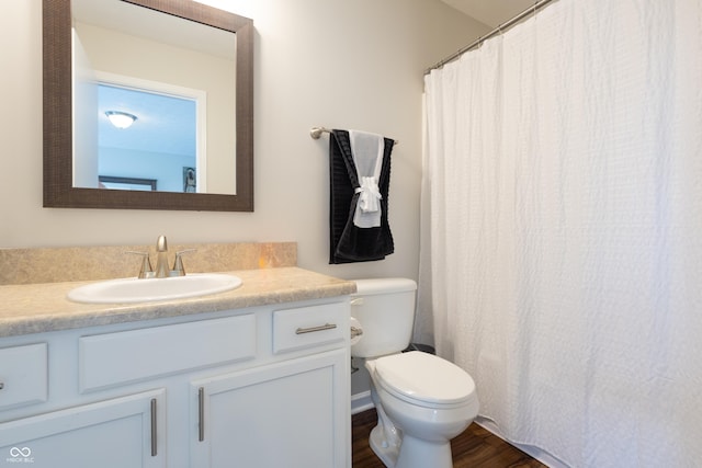 full bath with vanity, toilet, and wood finished floors