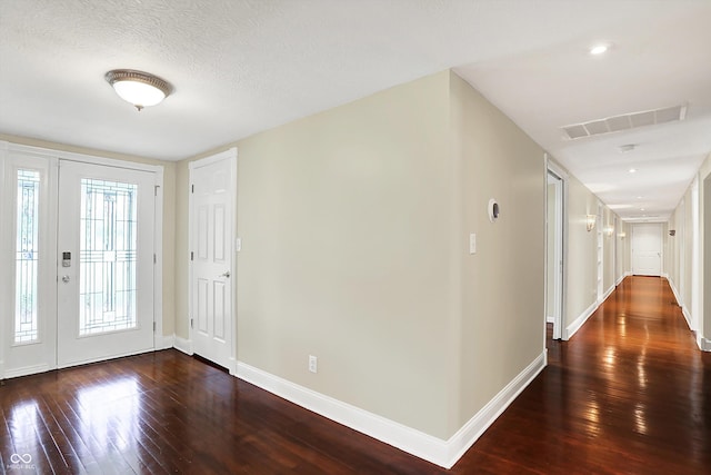 entrance foyer featuring dark wood-type flooring and baseboards