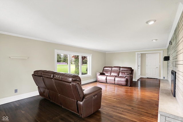 living room with baseboards, crown molding, a fireplace, and dark wood-type flooring