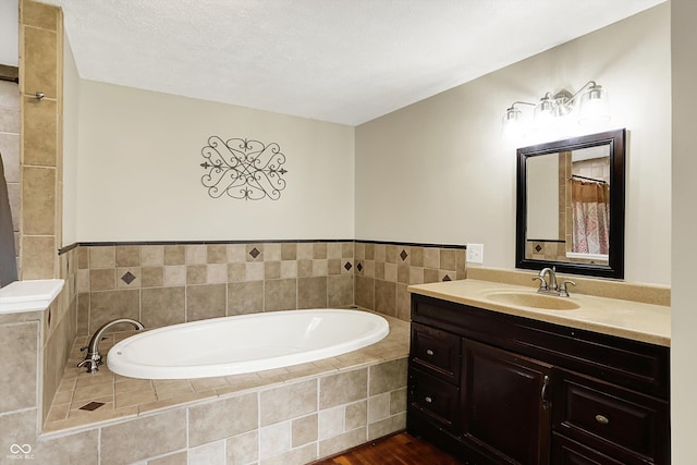 full bath with a bath, vanity, and wood finished floors