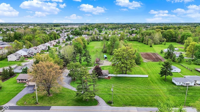 aerial perspective of suburban area featuring a tree filled landscape