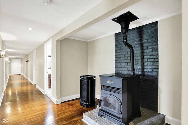 hall featuring dark wood-style floors, baseboards, crown molding, and recessed lighting
