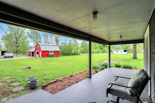 view of patio / terrace with an outbuilding
