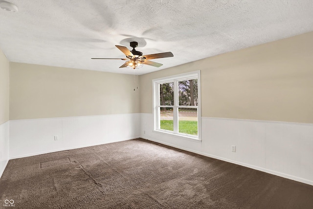 carpeted spare room with a smoke detector, a ceiling fan, a textured ceiling, and baseboards