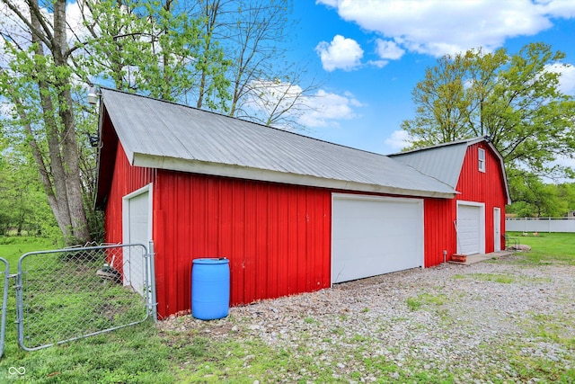 detached garage featuring fence