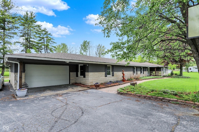 ranch-style house with an attached garage, a front lawn, driveway, brick siding, and roof with shingles