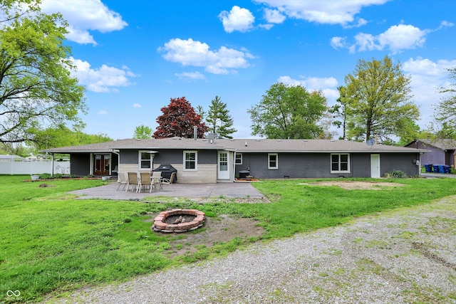 rear view of house featuring an outdoor fire pit and a patio