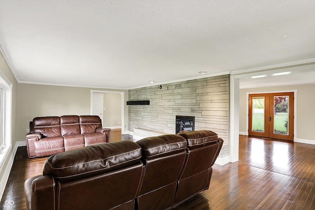 living area featuring a stone fireplace, crown molding, french doors, wood finished floors, and baseboards