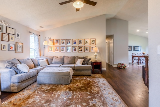 living room with vaulted ceiling, baseboards, visible vents, ceiling fan, and wood finished floors