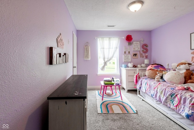 carpeted bedroom with a textured ceiling, a textured wall, and visible vents
