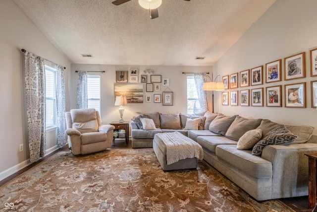 living area with a ceiling fan, baseboards, visible vents, and a textured ceiling