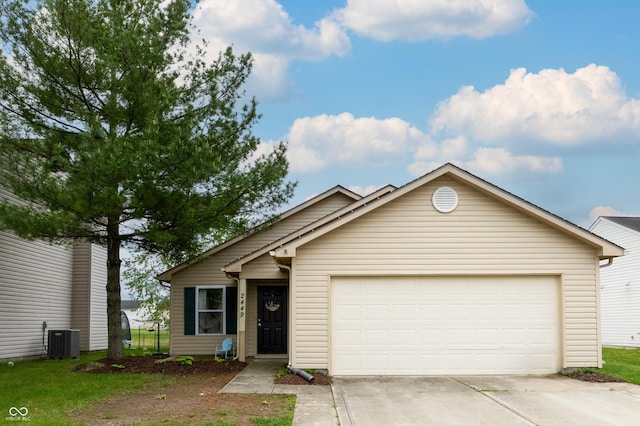 ranch-style home featuring cooling unit, driveway, and a garage