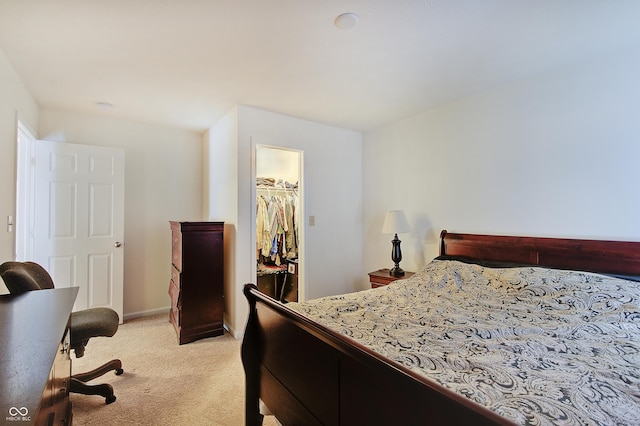 7303 Beal Ln, Indianapolis, IN 46217 - bedroom with light carpet, a walk in closet, a closet, and baseboards