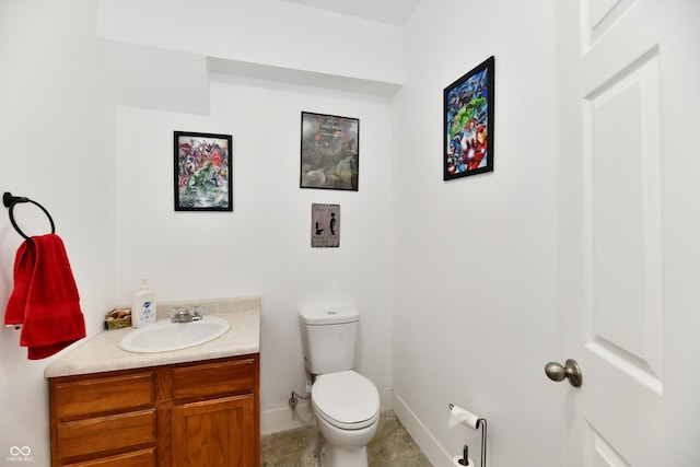 bathroom with vanity, baseboards, and toilet