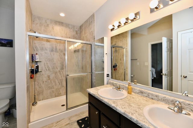 998 Cass Dr, Franklin, IN 46131 - bathroom featuring double vanity, toilet, a sink, and a stall shower