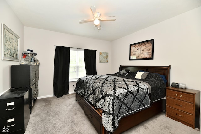 bedroom featuring light colored carpet, baseboards, and ceiling fan