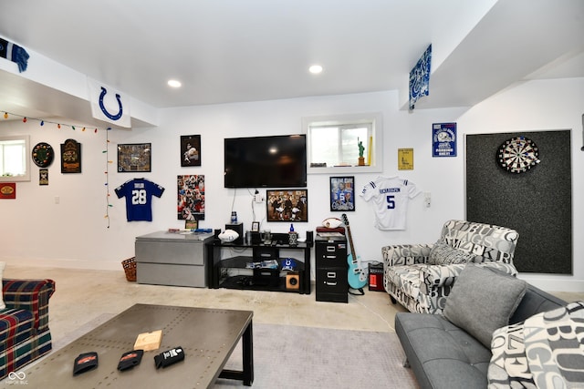 living room featuring recessed lighting, baseboards, and concrete flooring