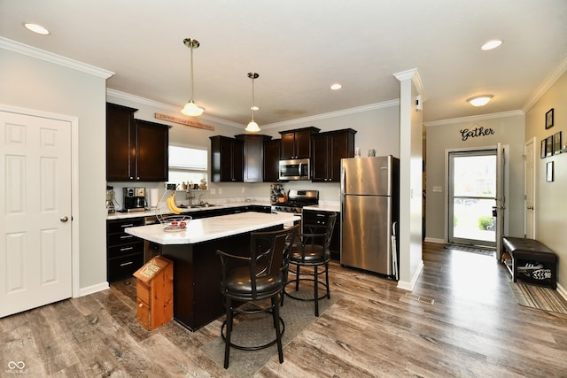 998 Cass Dr, Franklin, IN 46131 - kitchen featuring a breakfast bar, light countertops, stainless steel appliances, wood finished floors, and a kitchen island