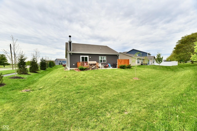 998 Cass Dr, Franklin, IN 46131 - rear view of property with a lawn, fence, a chimney, and a wooden deck