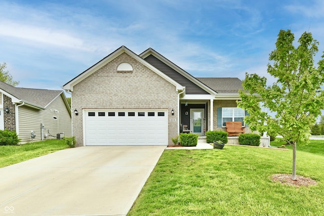 craftsman house with brick siding, a garage, driveway, and a front yard
