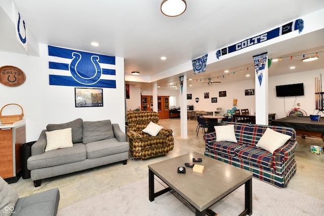 living room featuring recessed lighting and concrete flooring