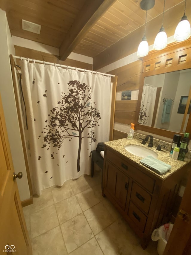 bathroom with vanity, beam ceiling, toilet, wood ceiling, and tile patterned floors