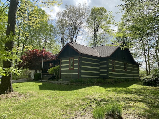 view of property exterior with log siding and a yard