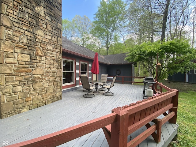 deck with grilling area and outdoor dining space