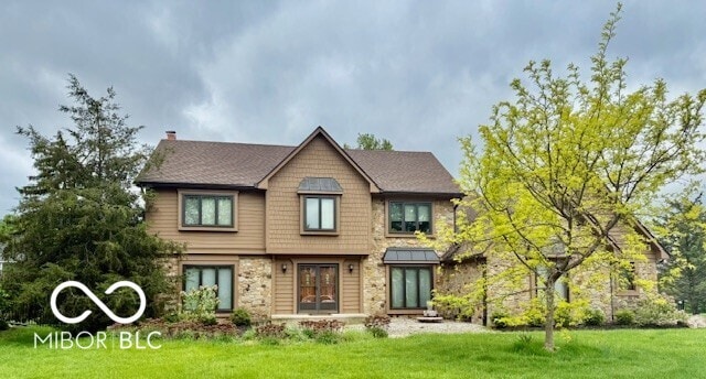 1421 Stoney Creek Cir, Carmel, IN 46032 - view of front of house with a front yard, stone siding, and a chimney