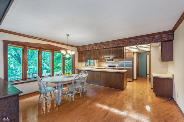 1421 Stoney Creek Cir, Carmel, IN 46032 - kitchen featuring appliances with stainless steel finishes, light wood-type flooring, a peninsula, crown molding, and a chandelier
