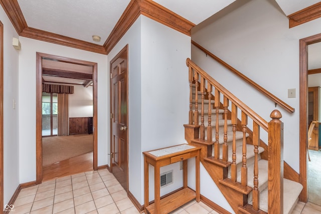 1421 Stoney Creek Cir, Carmel, IN 46032 - stairway featuring crown molding, tile patterned floors, baseboards, and wainscoting