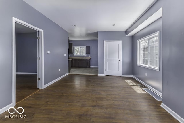 interior space with baseboards and dark wood-style floors
