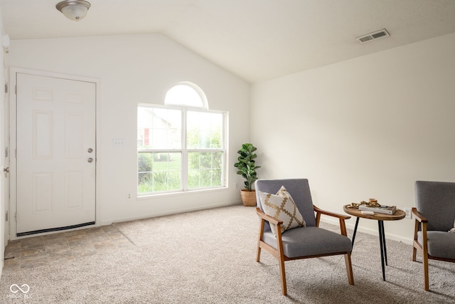 living area with baseboards, carpet, vaulted ceiling, and visible vents