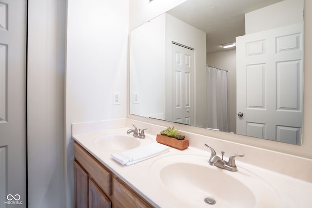 bathroom featuring a sink and double vanity