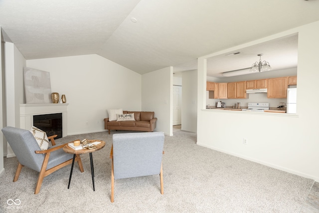 living room with baseboards, a fireplace, lofted ceiling, and light carpet