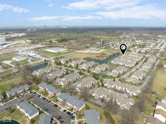 drone / aerial view featuring a water view and a residential view