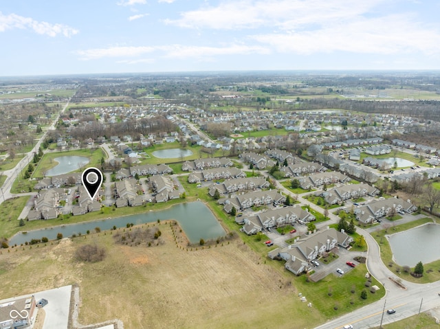 birds eye view of property with a residential view and a water view