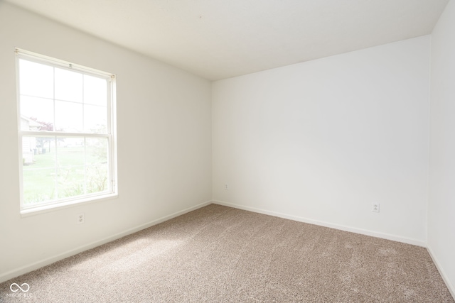 carpeted empty room with baseboards