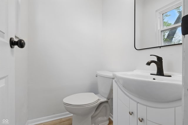 1116 Heatherwood Dr, Indianapolis, IN 46241 - bathroom with vanity, baseboards, toilet, and wood finished floors