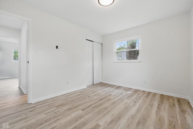 1116 Heatherwood Dr, Indianapolis, IN 46241 - unfurnished bedroom featuring baseboards, light wood finished floors, and a closet