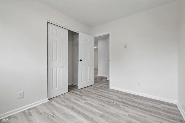 1116 Heatherwood Dr, Indianapolis, IN 46241 - unfurnished bedroom with light wood-style floors, baseboards, and a closet